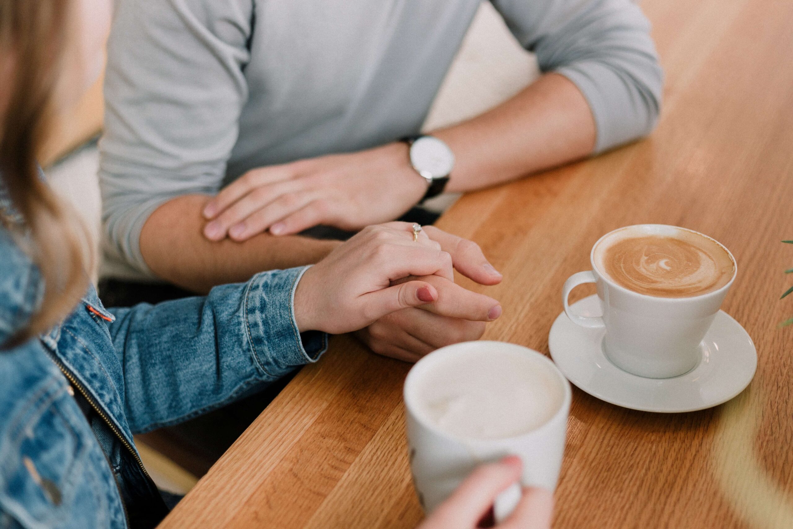 A man and woman have coffee together