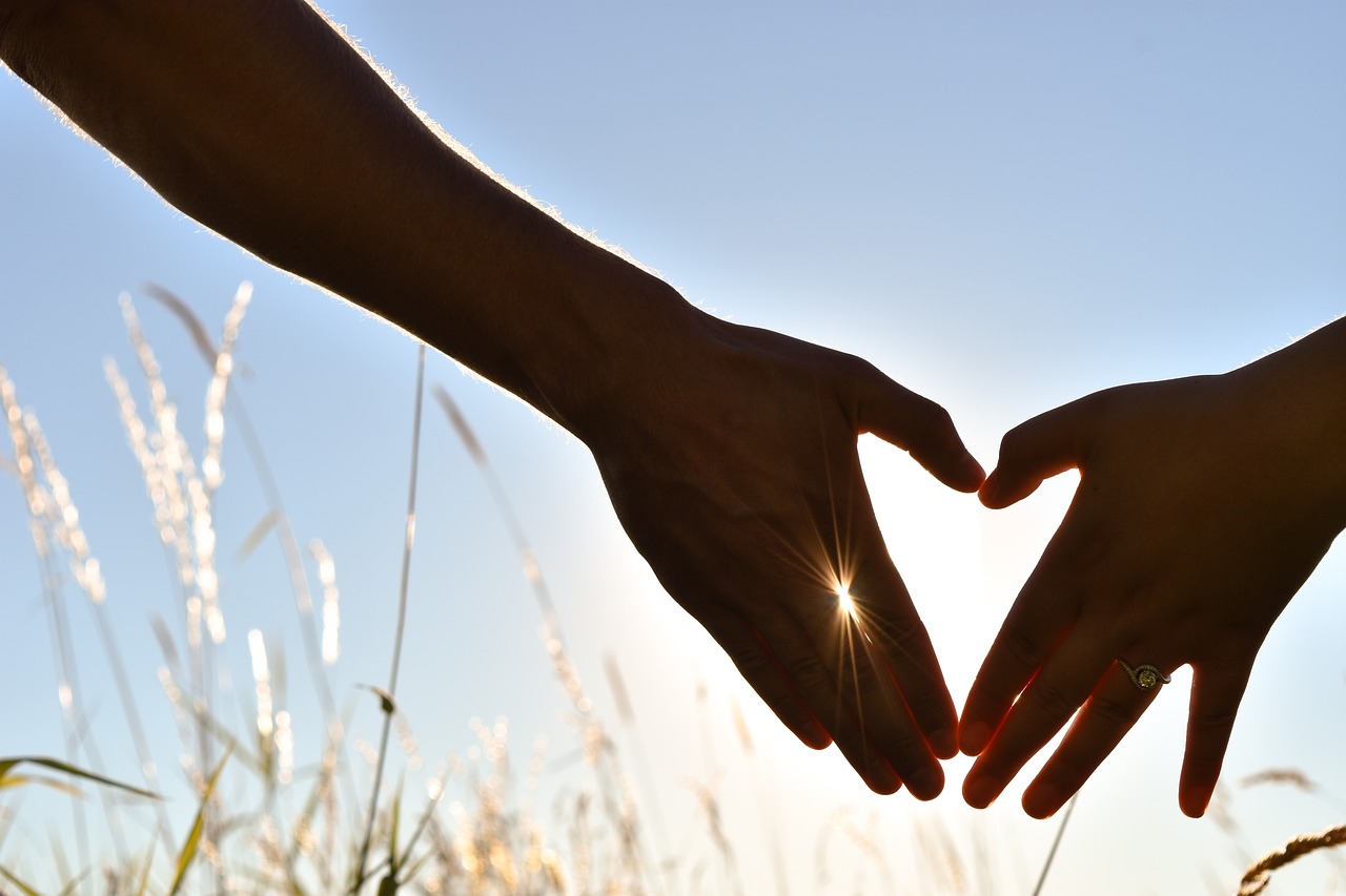 Two hands forming heart silhouette